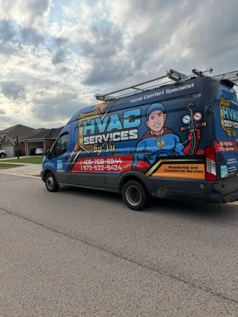 HVAC Services by Vu wrapped service van parked on a residential street